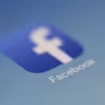 Close-up view of the Facebook app logo on a digital screen with blurred background.